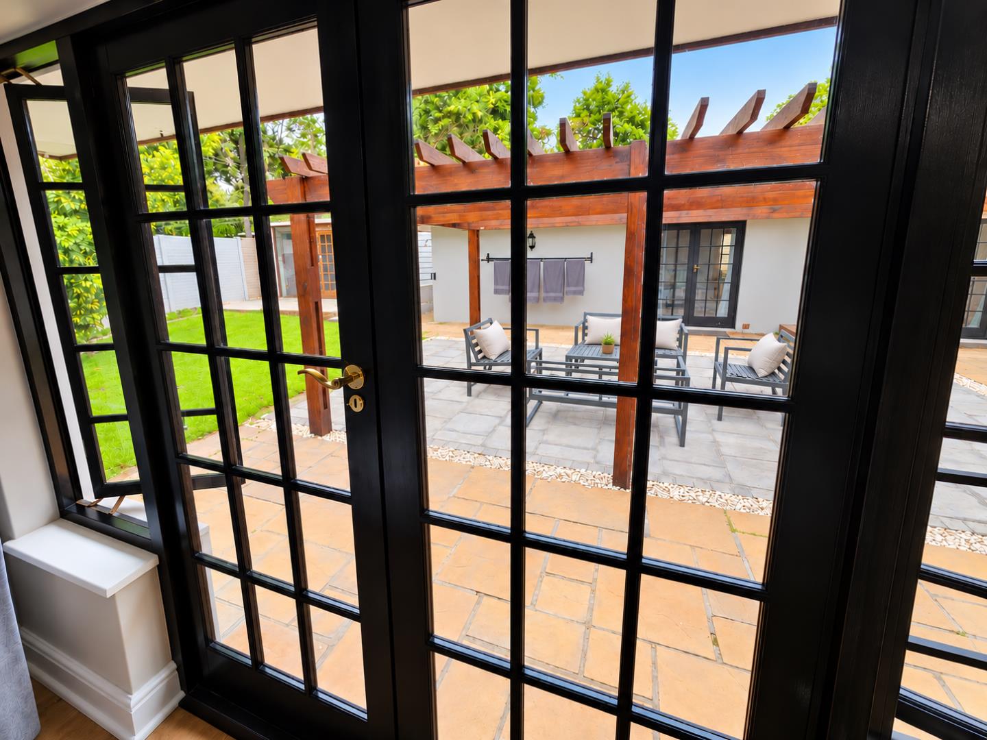 769572_Bright_French_Doors_Overlooking_Pergola_Patio.png