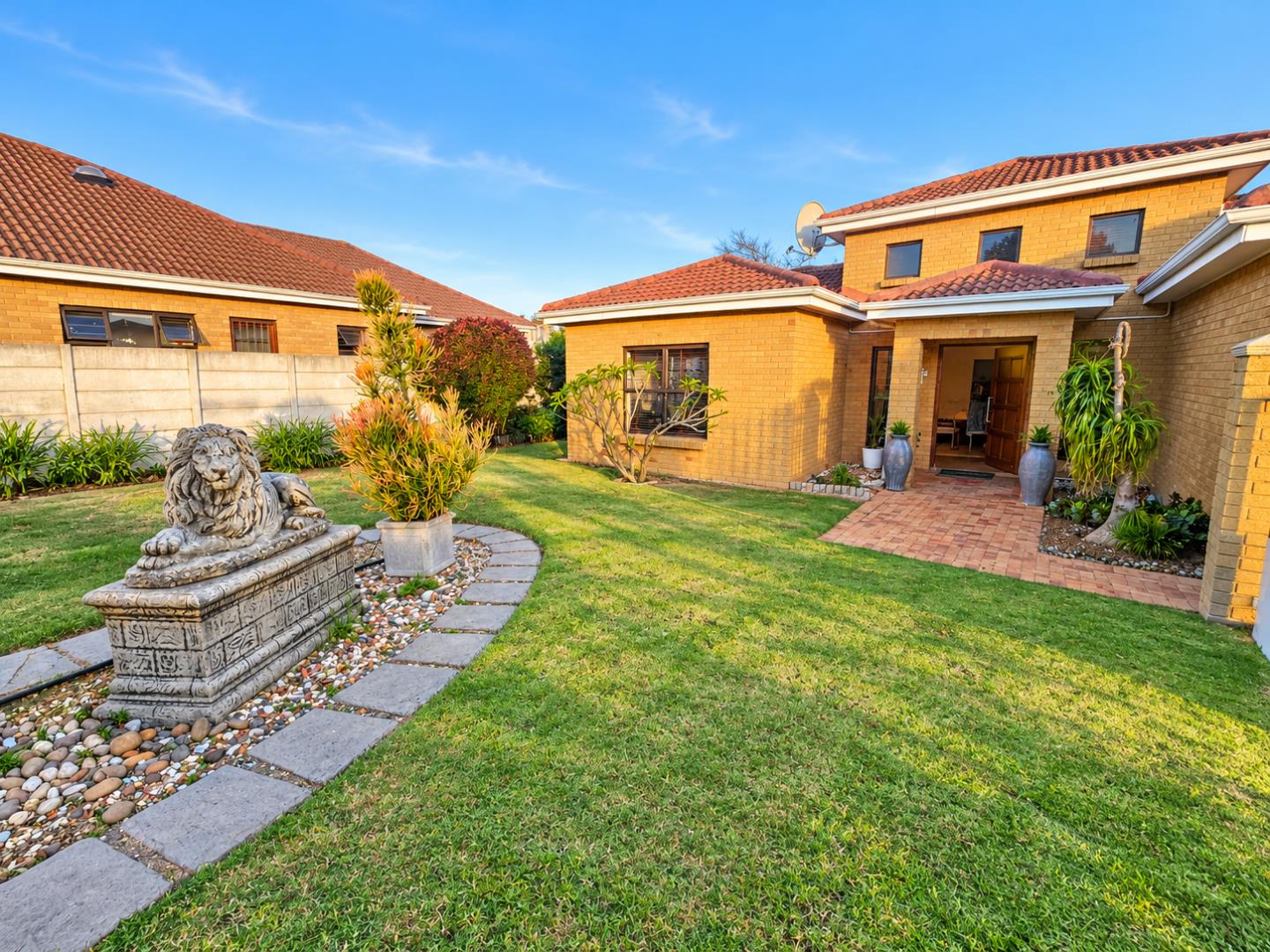 769601_Sunlit_Courtyard_with_Lion_Statue_and_Garden.png